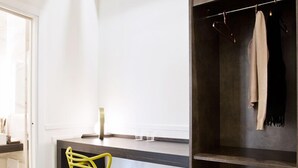 A modern kitchen with a white countertop, a yellow chair, and a black storage unit. - Umberto34 - Luxury Home (Naples)