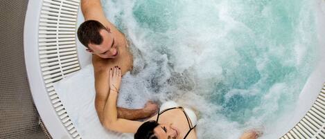 A hot tub with two people lying in it.