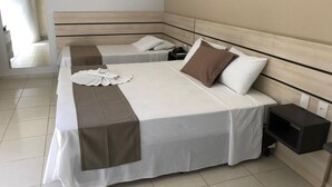 A hotel room with two beds, a bedside table, and a nightstand. - Dallas Hotel (Palotina)