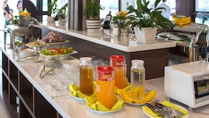 A buffet setup with various food items, drinks, and a toaster. - Cat Ba White Pearl (Hai Phong)