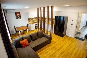 Family Suite | Living area | 88-cm LED TV with cable channels, TV