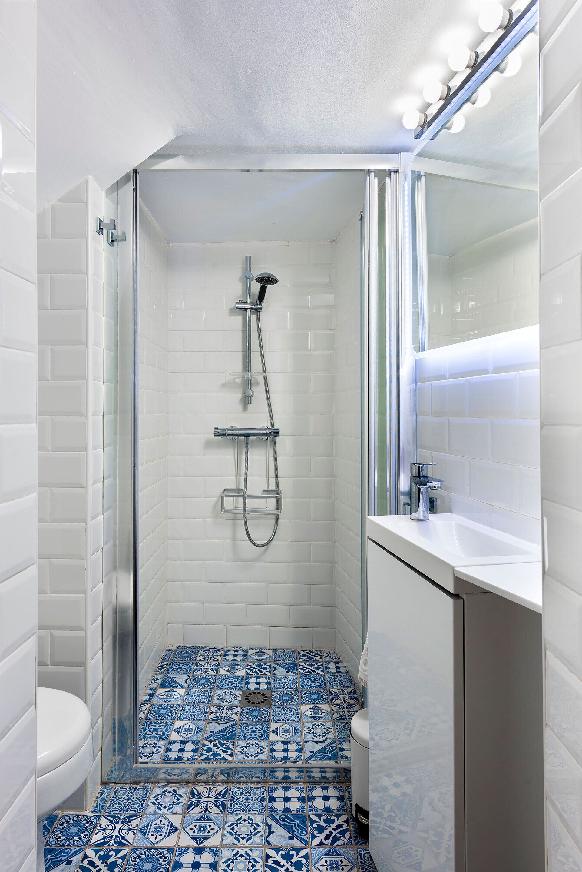 A bathroom with a shower, toilet, and sink.