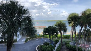 A parking area with a view of a body of water and a dock. - Marco Island Riverside Condo - Comfort Meets Coastal Charm (Marco Island)