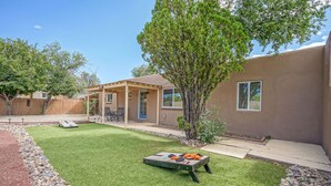 A backyard with a patio, a small tree, and a grassy lawn. - 4bd,2ba Remodeled North Valley Home w/ large yard (Los Ranchos De Albuquerque)