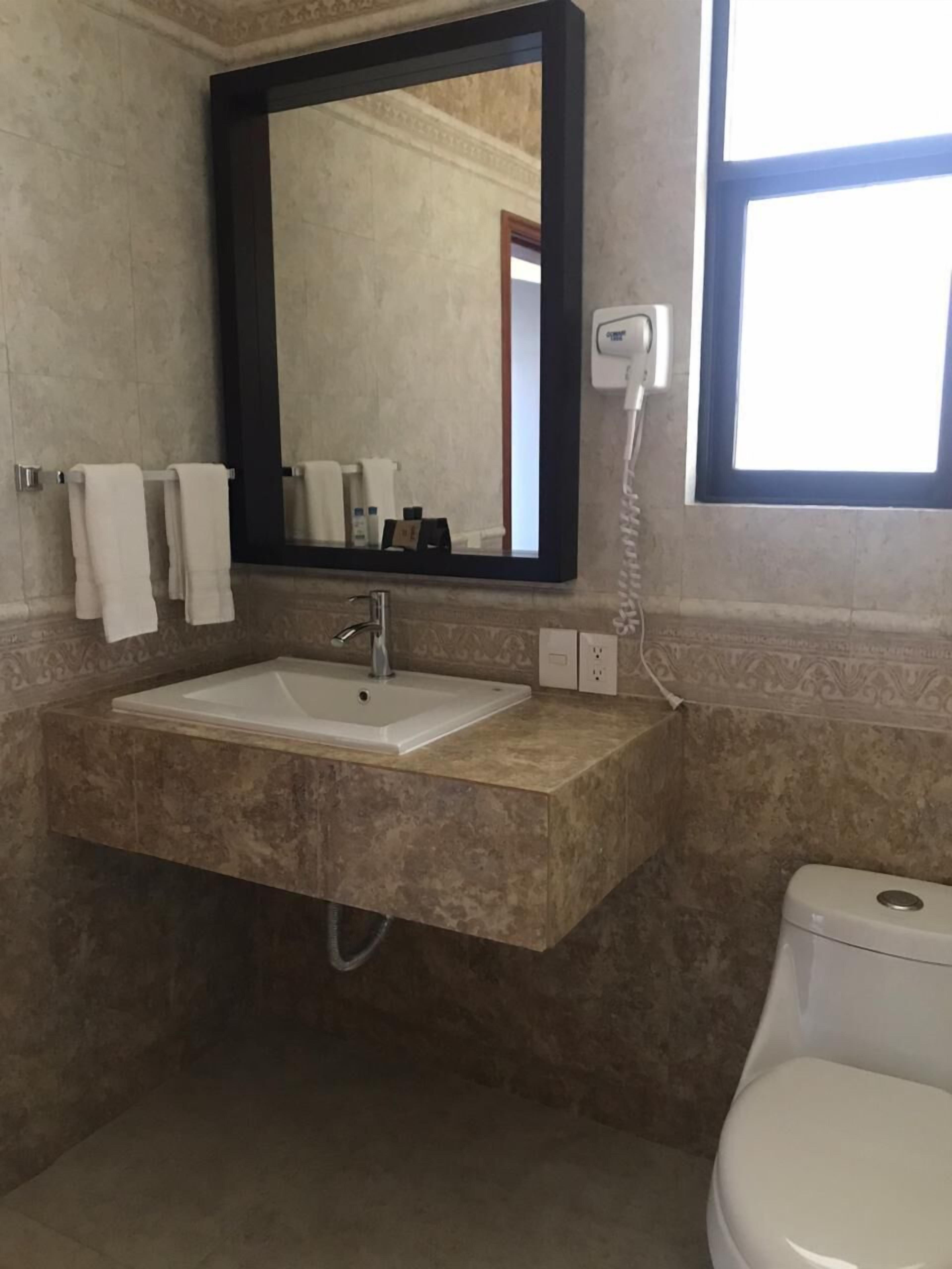 comfort room, 1 queen bed | bathroom | hair dryer, towels, soap, shampoo