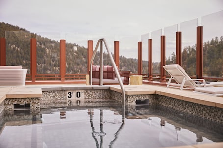 A rooftop infinity pool with a clear view of the surrounding landscape, a lounge area with chairs, and a hot tub.. Monarch Casino Resort Spa Black Hawk