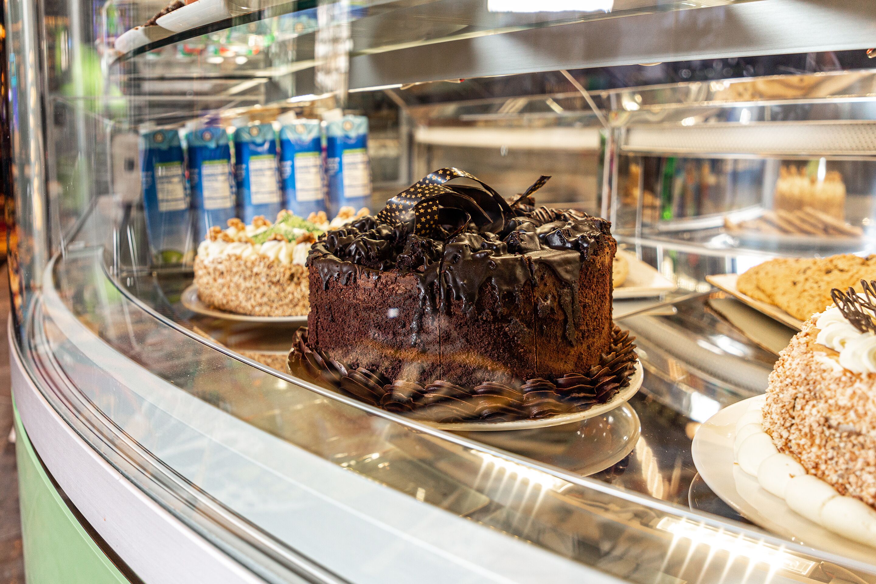 A bakery display case with various cakes and pastries.