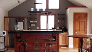 A spacious kitchen with a large island, wooden beams, and a high ceiling. - ⚓Captain Bill's Guest House and heated pool access⚓ (Poland)