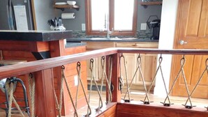 A wooden staircase with a rope railing, leading to a lower level. - ⚓Captain Bill's Guest House and heated pool access⚓ (Poland)