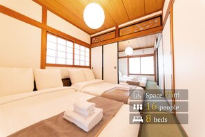 A traditional Japanese-style hotel room with 8 beds, a tatami mat floor, and sliding doors. - Villa Tengachaya-Nishi (Osaka)