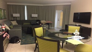 Relax in this inviting space with a sofa set, coffee table, and TV.
