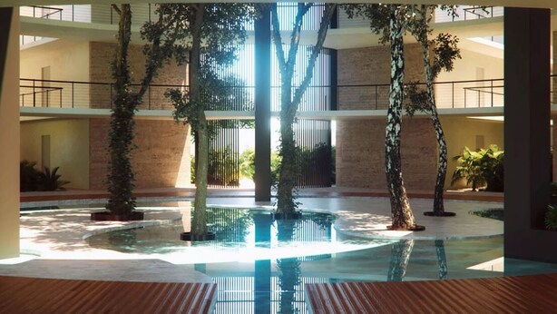 A spacious indoor atrium with a central water feature, multiple levels, and surrounding greenery. - Trendy Studio, PANORAMIC D 202 – By Salt-Kisses (Tulum)
