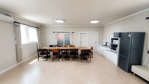 A modern kitchen with a refrigerator, microwave, and sink. - Ulsan Ganjeolgot View Pension (Ulsan)