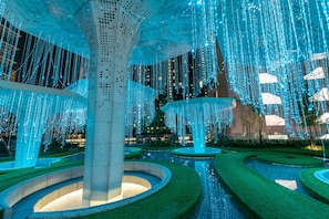 A modern architectural structure with a central column and surrounding circular seating areas.