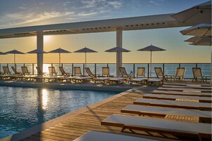 季节性开放的室外游泳池，池畔遮阳伞，日光浴躺椅