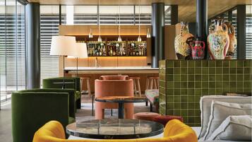 Eine moderne Bar mit verschiedenen Sitzgelegenheiten, darunter eine Bar und mehrere Stühle.