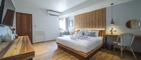 A modern bedroom with a wooden bed, a desk, and a chair.