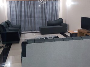 Apartment, 4 Bedrooms, Ocean View | Living room | 42-inch LED TV with cable channels, TV, DVD player - Alpha House (Mombasa)
