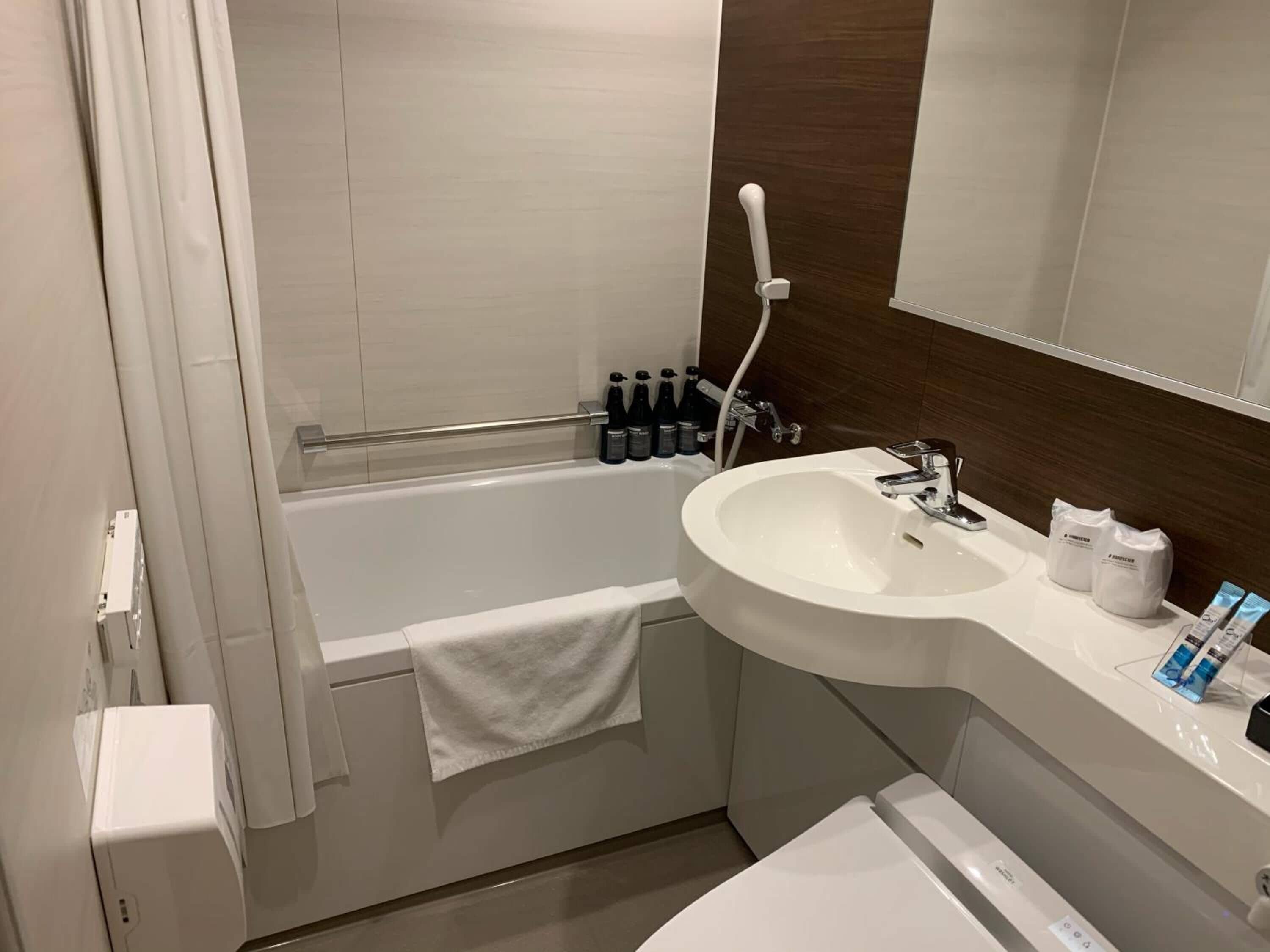 Combined shower/tub, slippers, towels, soap