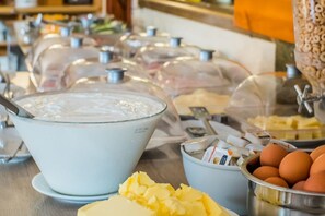 A buffet setup with various food items and condiments. - Hotel Marlena - Adults Only (Hersonissos)
