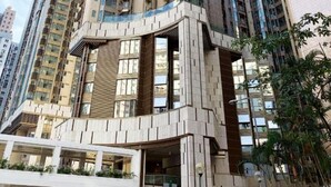 A high-rise building with multiple balconies and a modern architectural design. - Hotel Alexandra (Hong Kong)