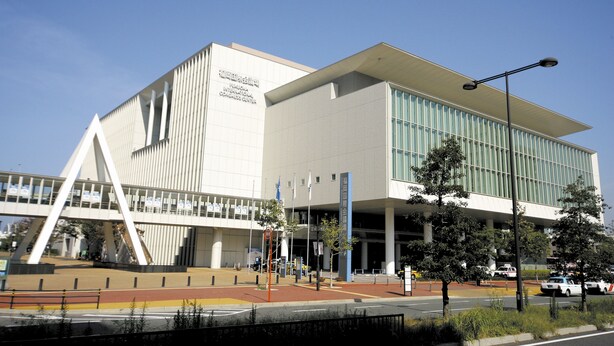 A modern building with a prominent entrance and a covered walkway. - Tenjin Higashi Russo (Fukuoka)