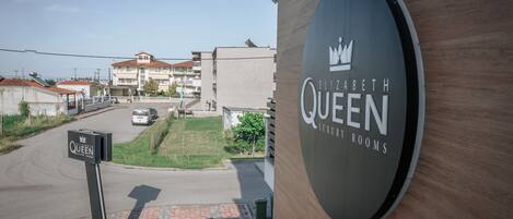 Un immeuble sur lequel on peut lire l’inscription : « Elizabeth Queen, chambres de luxe ».