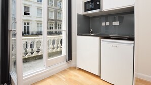 A modern kitchen with a built-in microwave, a sink, and a dishwasher.
