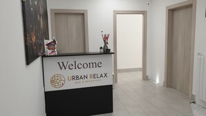 A reception desk with a sign reading "Welcome URBAN RELAX BED & BREAKFAST". - Urban Relax (Favara)