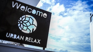 A sign with "Welcome" and "URBAN RELAX" text, and a circular logo. - Urban Relax (Favara)