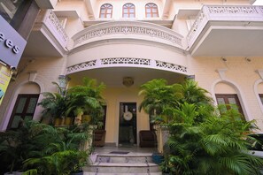 A building with a grand entrance, multiple windows, and a balcony with intricate railings. - Shree Ganesha Residency (Varanasi)