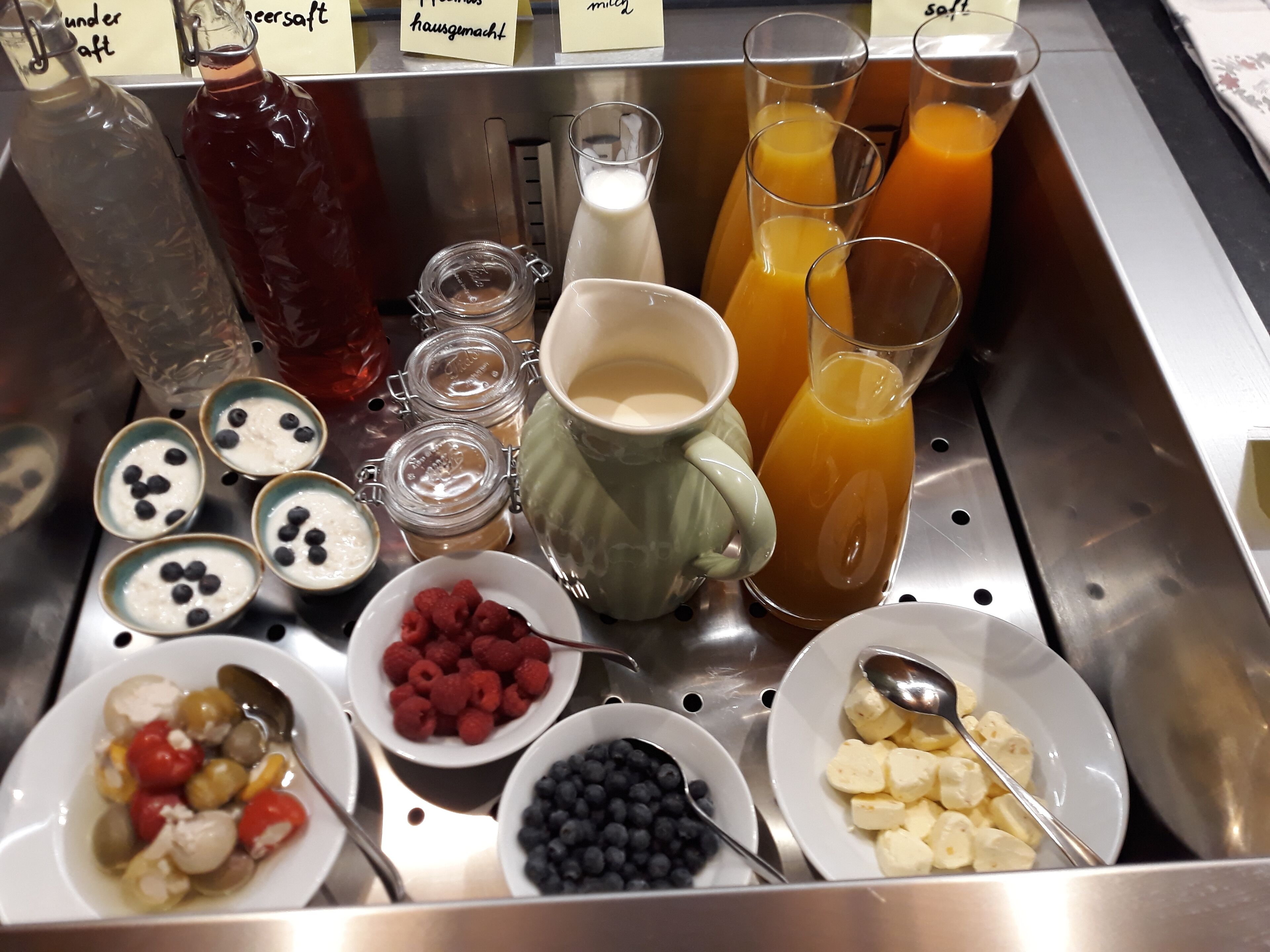 A breakfast buffet with various food items and beverages.
