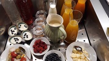 A breakfast buffet with various food items and beverages.