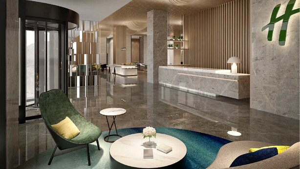 A modern lobby with a reception desk, a green armchair, a round coffee table, and a marble floor. - Holiday Inn Hotel and Suites Suzhou Yangcheng Lake by IHG (Suzhou)