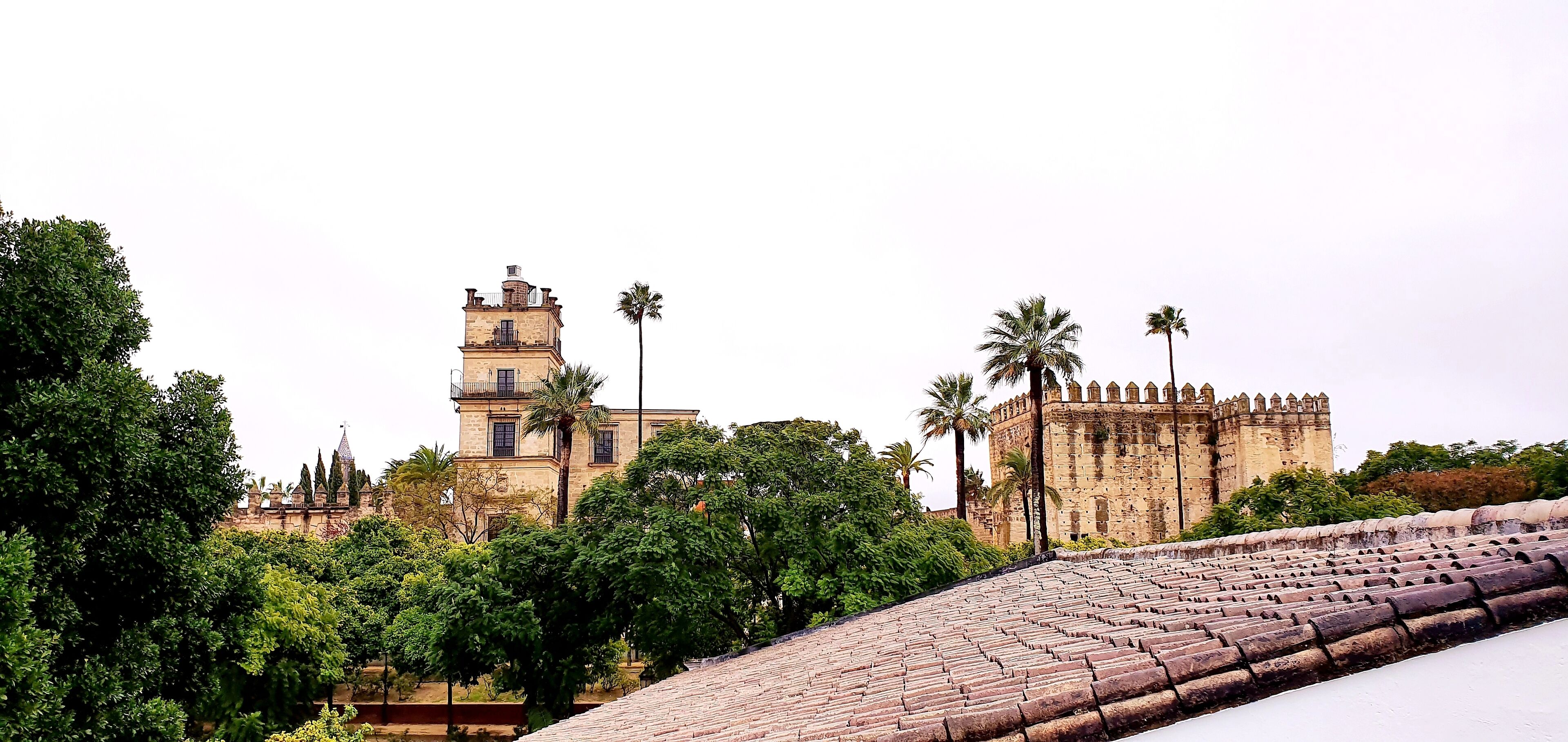 A historic building with a bell tower and a fortified structure.