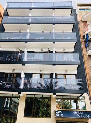 A multi-story hotel with balconies, large windows, and a sign for Hotel Rosabel. - Hotel Rosabel (Benidorm)
