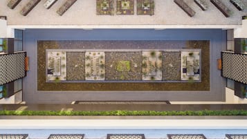 A rooftop garden with multiple planters and a central water feature.
