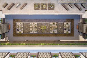 A rooftop garden with multiple planters and a central water feature.