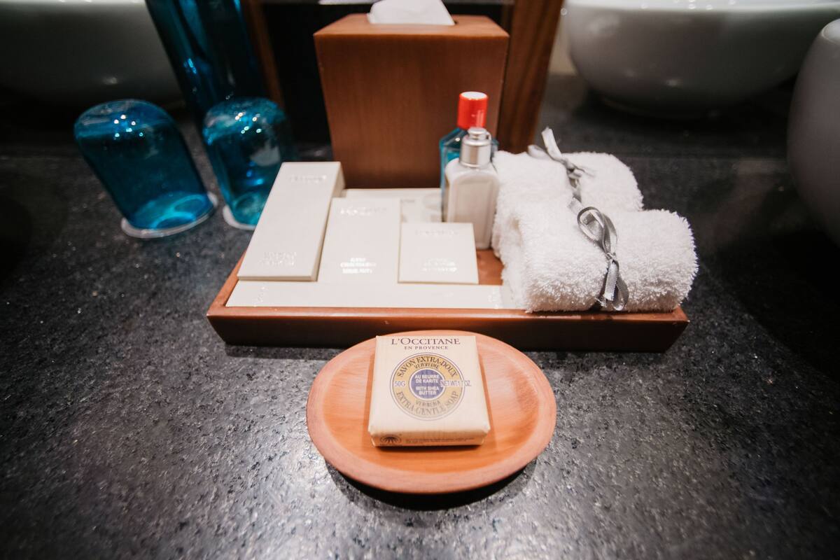 designer toiletries, hair dryer, bathrobes, slippers