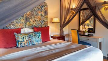 A bedroom with a bed, a desk, a chair, a lamp, and a mirror.