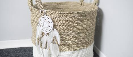 A woven basket with a handle and a decorative white tag.