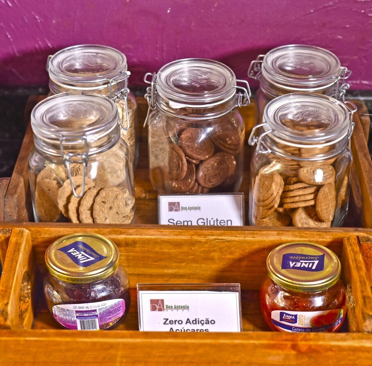 A display of food items in glass jars with labels indicating they are gluten-free and sugar-free.