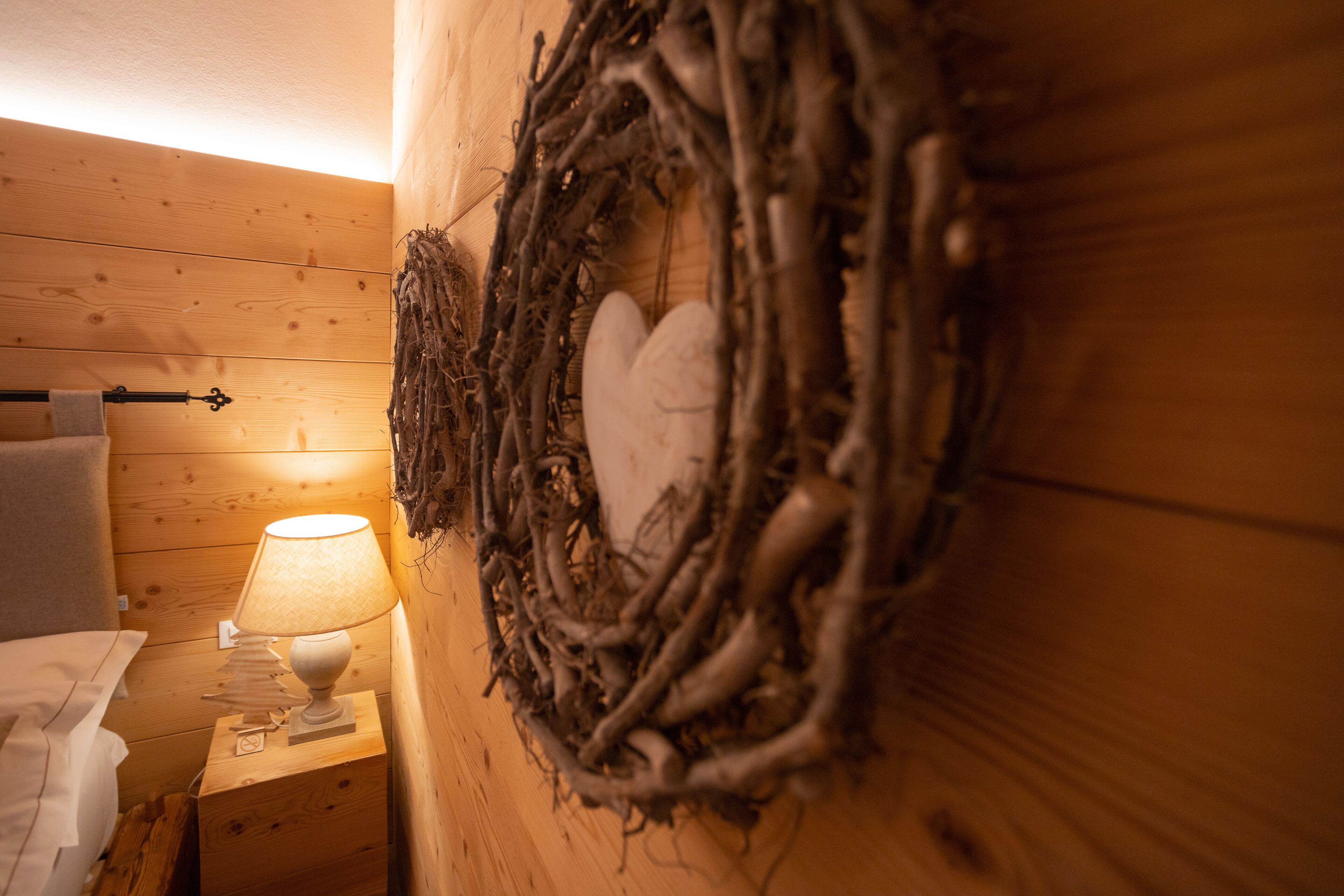 A wooden wall with a nest-like decoration containing a white object.