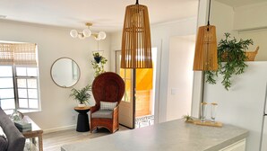 A modern kitchen with a large island, pendant lights, and a wicker chair. - South Oceanside 1br/1bath, clean and beach close (Oceanside)