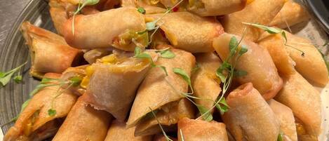 A plate of spring rolls garnished with microgreens.