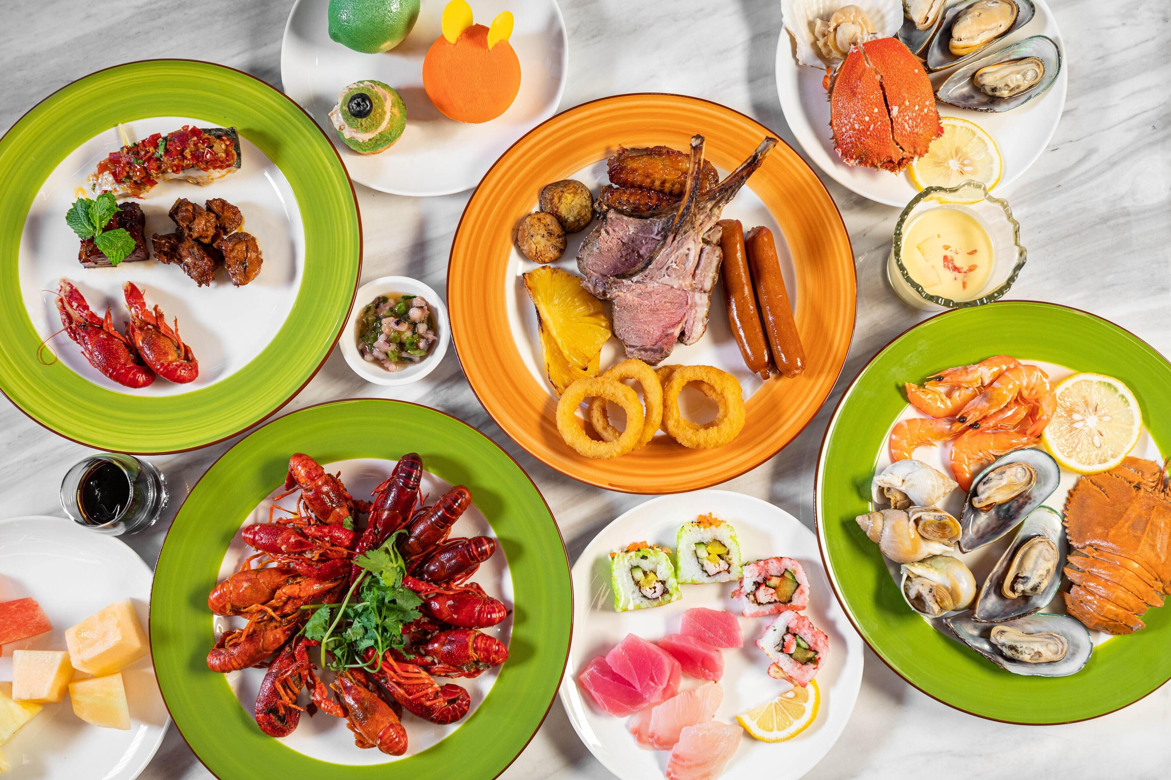 A variety of seafood dishes on multiple plates.