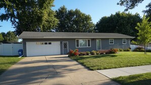 A two-story house with a garage, a front lawn, and a driveway. - 5 Bedrooms and a Great Location (Sioux Falls)