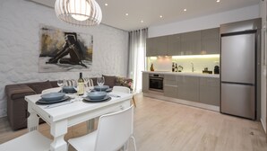 A modern kitchen with a built-in oven and a stainless steel refrigerator. - Elegant Apartments (Naxos)