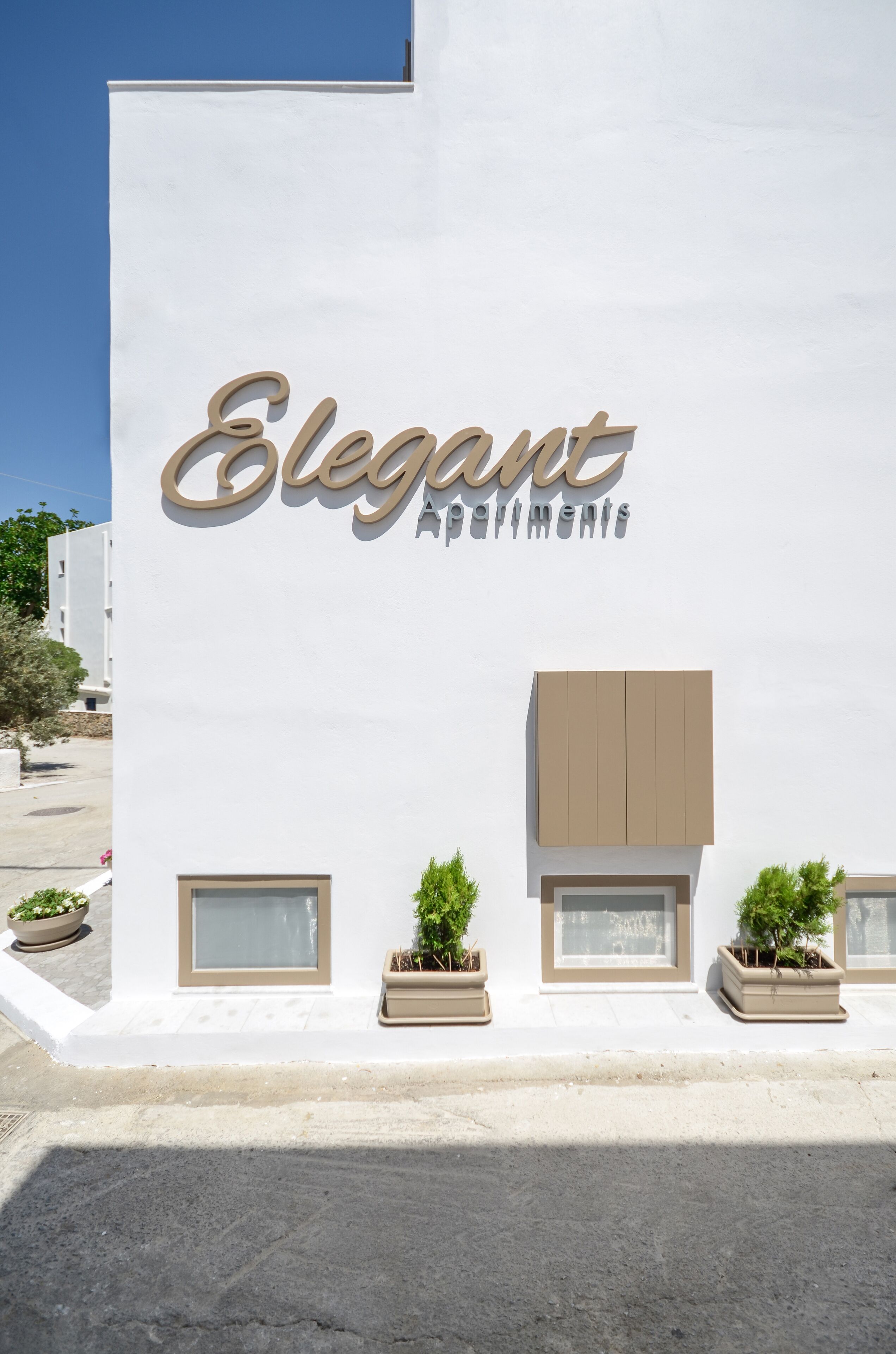 A building with a sign reading "Elegant Apartments."