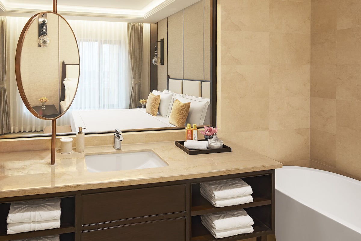 deluxe suite | bathroom | rainfall showerhead, designer toiletries, hair dryer, bathrobes